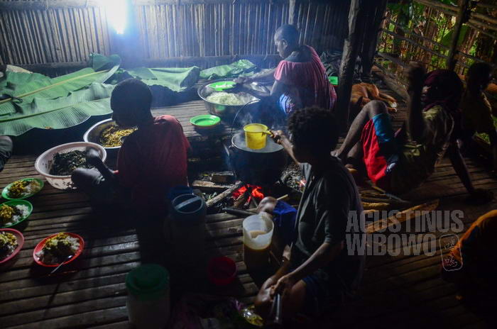 Para warga pengungsi menyiapkan makanan untuk pelayat.