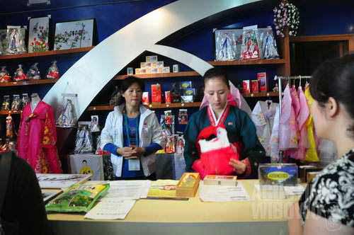 North Korean ladies offering stamps and books authored by the Kims in World Expo Shanghai 2010 (Agustinus Wibowo)