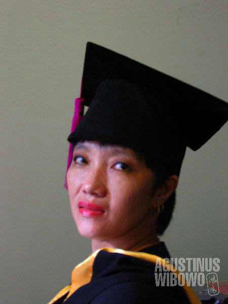 Mama, wearing my academic dress. She did not finish her primary education, as the school was forced to close by the Suharto regime. But her dream is to learn, learn a lot, and be a real university student