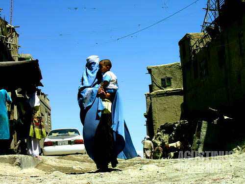 Woman in burqa, walking through the alleys of Deh Afghanan