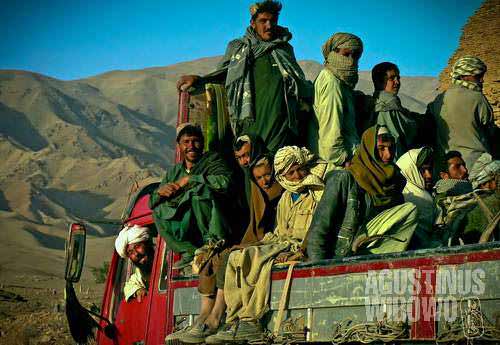 Villagers travelling on the truck in Afghanistan western provinces. The central route of Afghanistan connecting Herat to Kabul is unpaved for about 900 km. Public transport is extremely difficult and villagers rely on hitchhiking trucks to travel around.