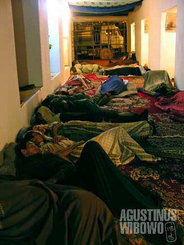 Travellers (musafirs) sleeping on the floor of restaurant along the central route of Afghanistan. The restaurants also serve as hotel for passengers. Along the isolated central route, the most common way of travelling is by hitchhiking a truck, like these
