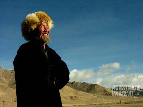 Kyrgyz man in Alichur, wearing the traditional furry hat and cloak, suitable for the harsh winter in the mountainous Pamir